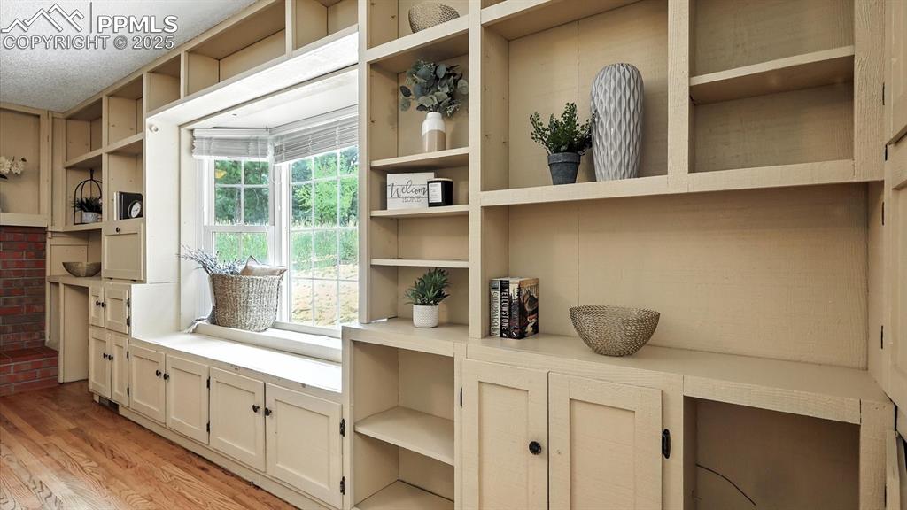 Image 21 of 50: Wall of built-ins and bay window in the Family Room.