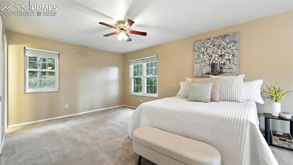 Image 30 of 50: The primary suite is a true retreat with a sitting area, double closets, &
