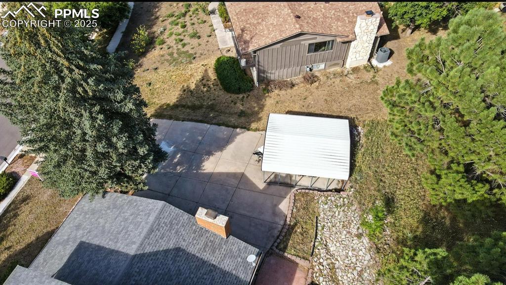 Image 47 of 50: Detached carport for small boat, camper, or additional parking on extended