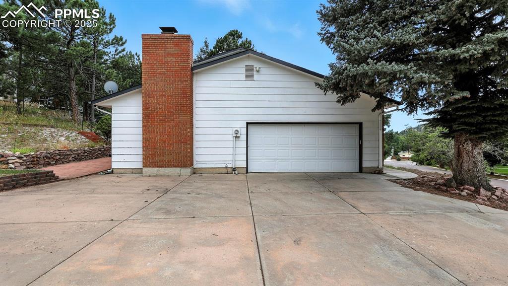Image 49 of 50: Expanded driveway and 2-car oversized garage with door opener.