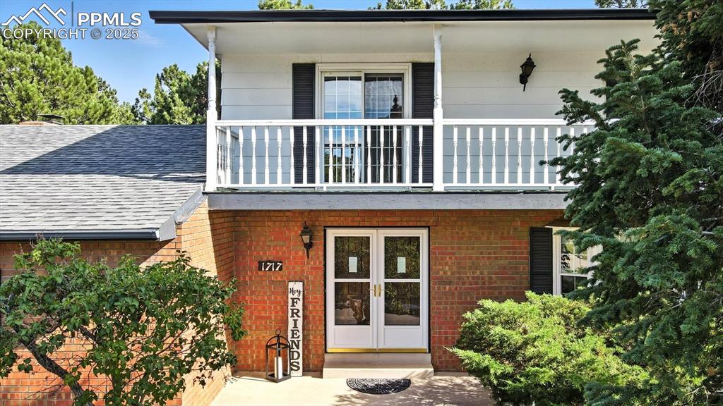 Image 5 of 50: Aerial view of front entrance and upper level balcony.