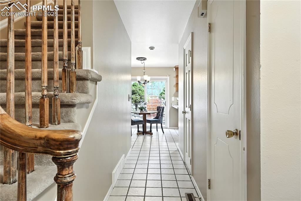 Image 6 of 50: Tiled entry and front hallway.