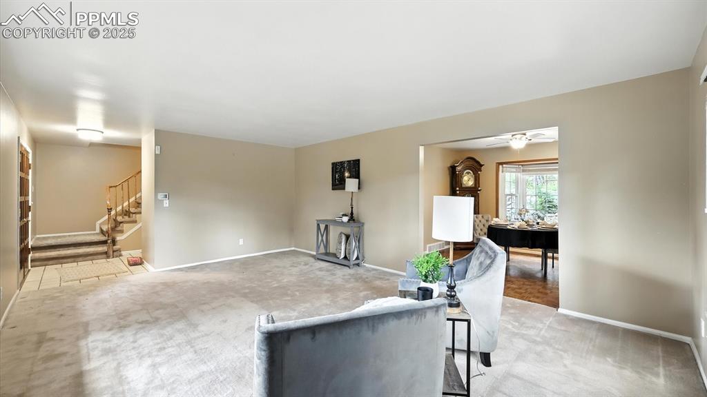 Image 8 of 50: Bright & airy living room featuring neutral carpet & a bay window.
