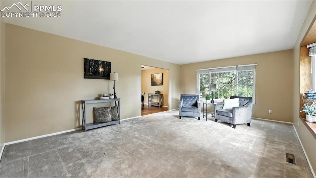 Image 9 of 50: The Living Room flows into the formal Dining Room.