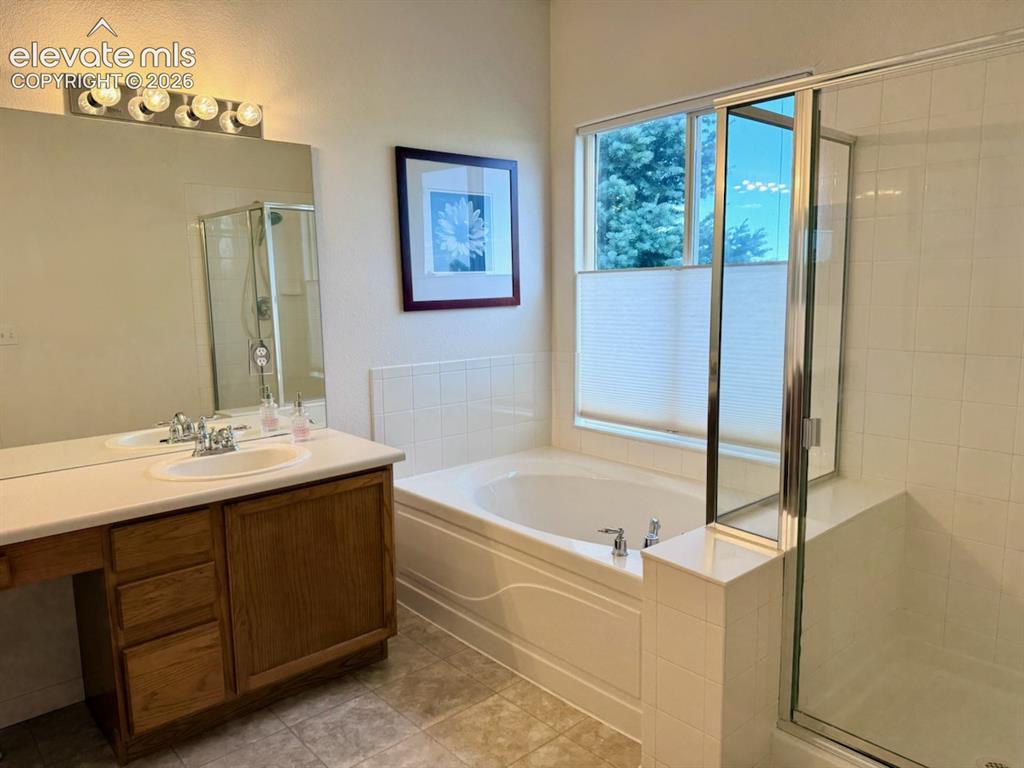 Image 19 of 42: Master bathroom soaking tub and stand alone shower