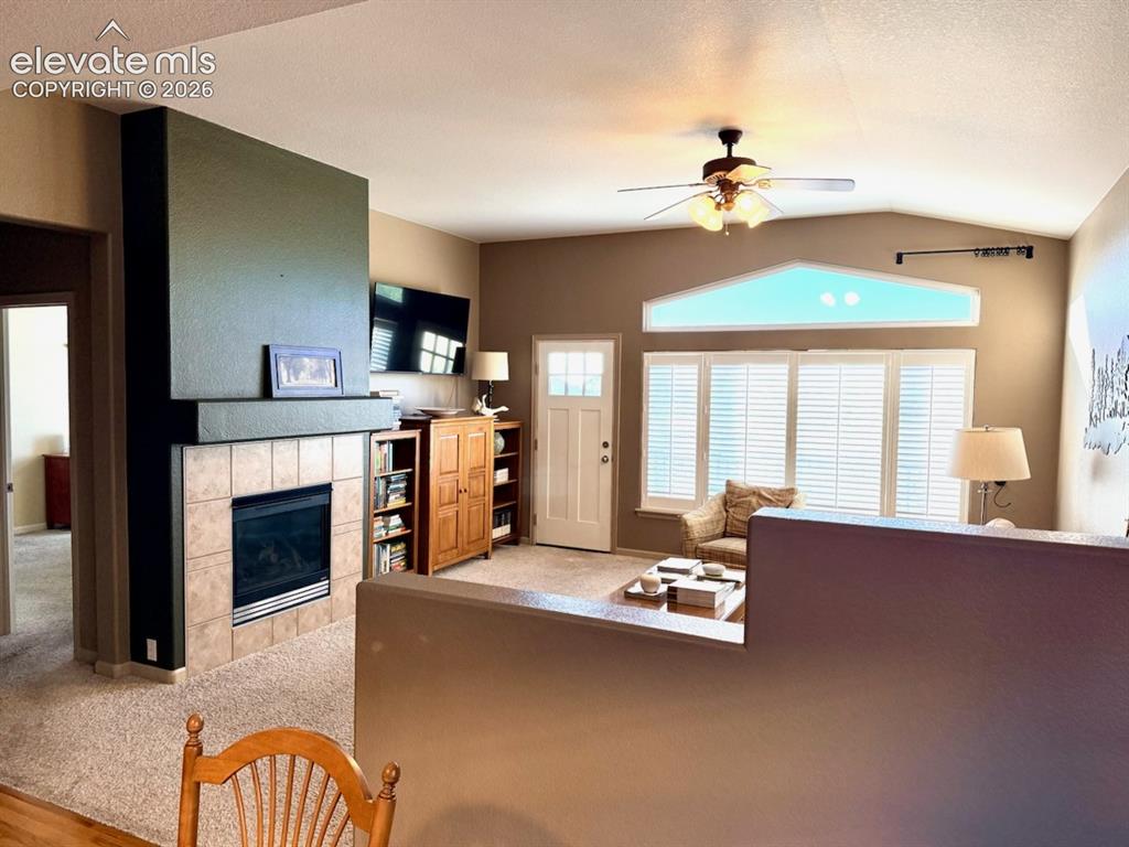 Image 33 of 42: Family room separated by a half wall