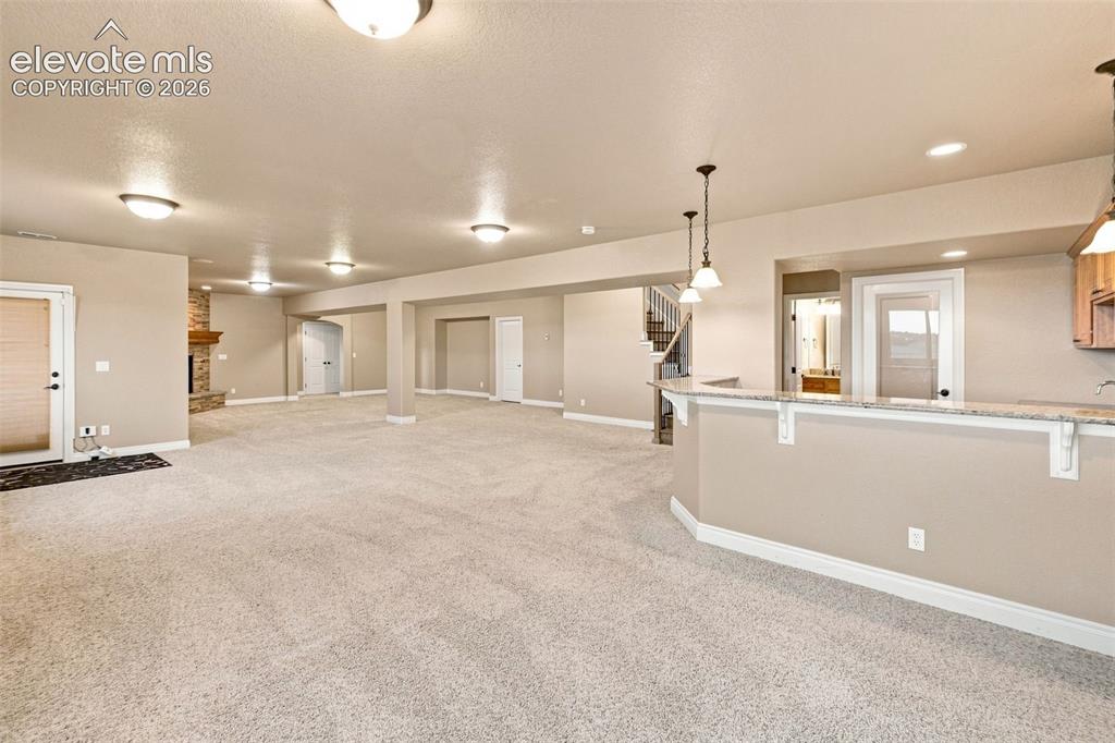 Image 31 of 47: Huge gaming area and recreation room in the lower walkout level!