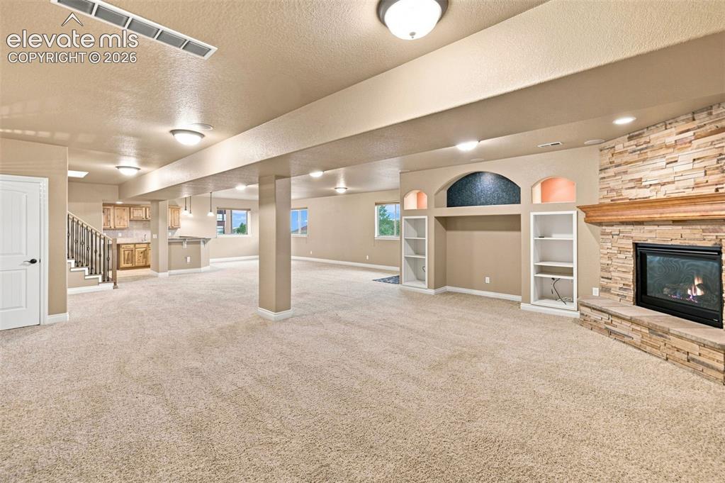 Image 46 of 47: TV area - open to large great room baement w/ room for gaming and play! Wal