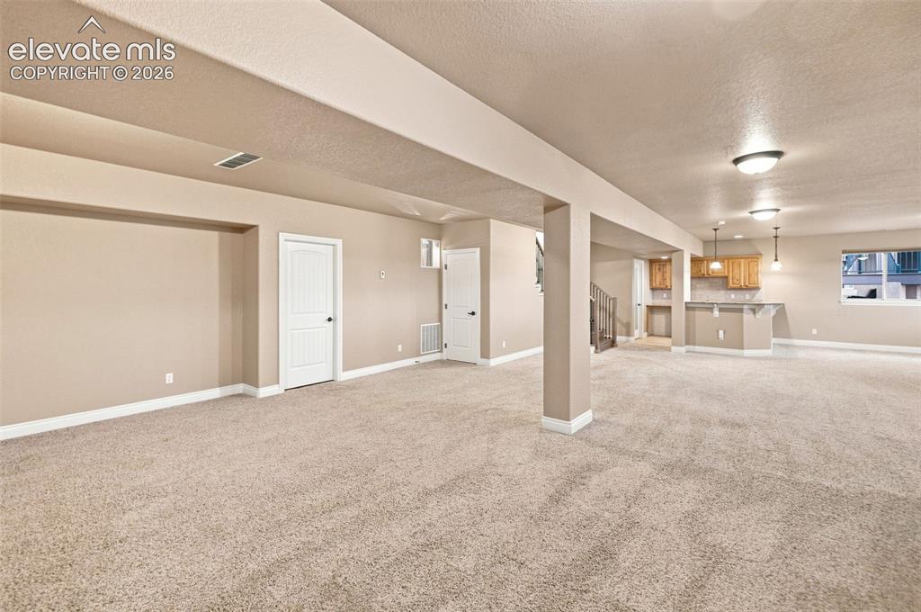 Image 47 of 47: TV area - open to large great room baement w/ room for gaming and play! Wal