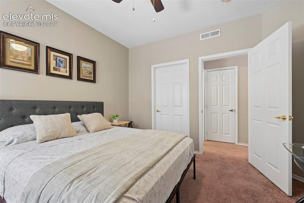 Image 23 of 36: Interior room featuring neutral wall paint, ceiling fan, and carpeted floor