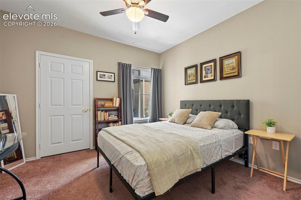 Image 26 of 36: Bedroom featuring a neutral wall color, ceiling fan with light fixture, win