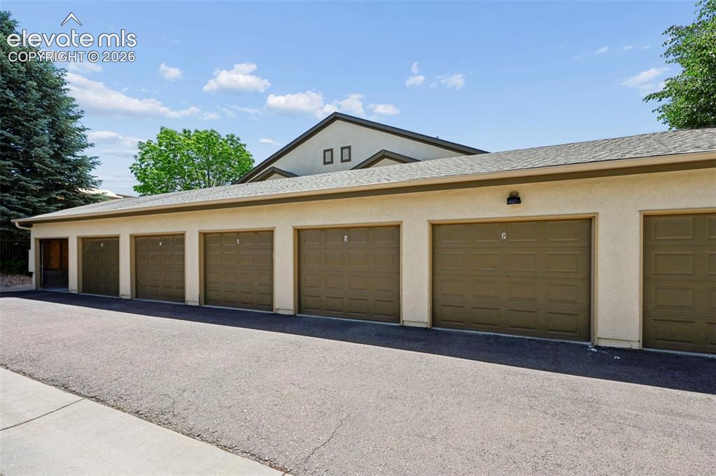 Image 34 of 36: Multi-car garage structure with six individual garage doors