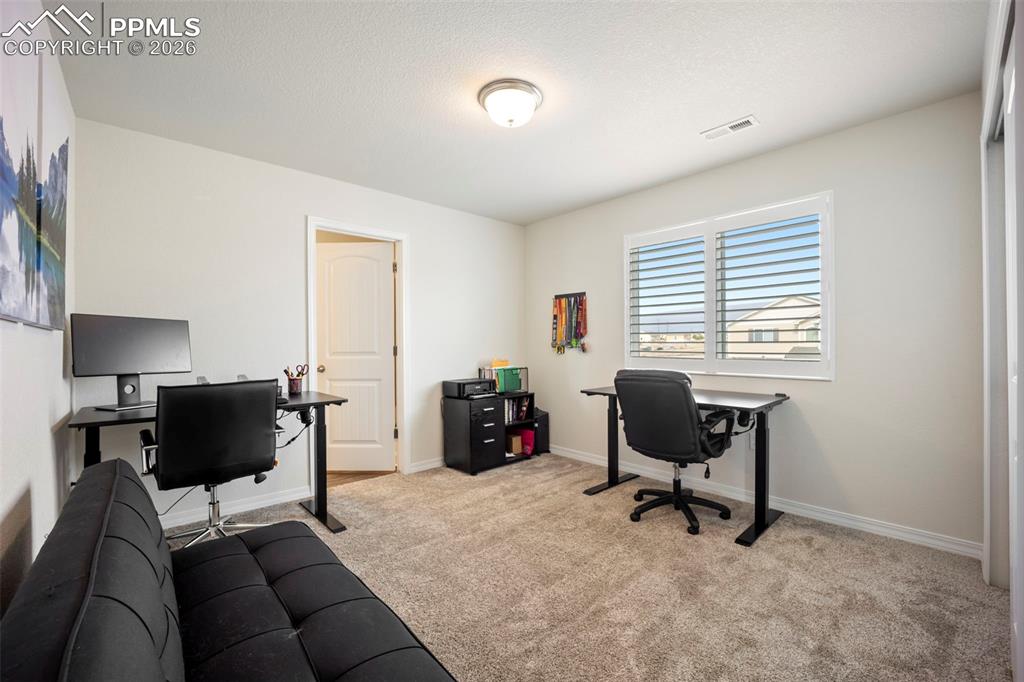 Image 23 of 38: Upper bedroom used as office with mountain views