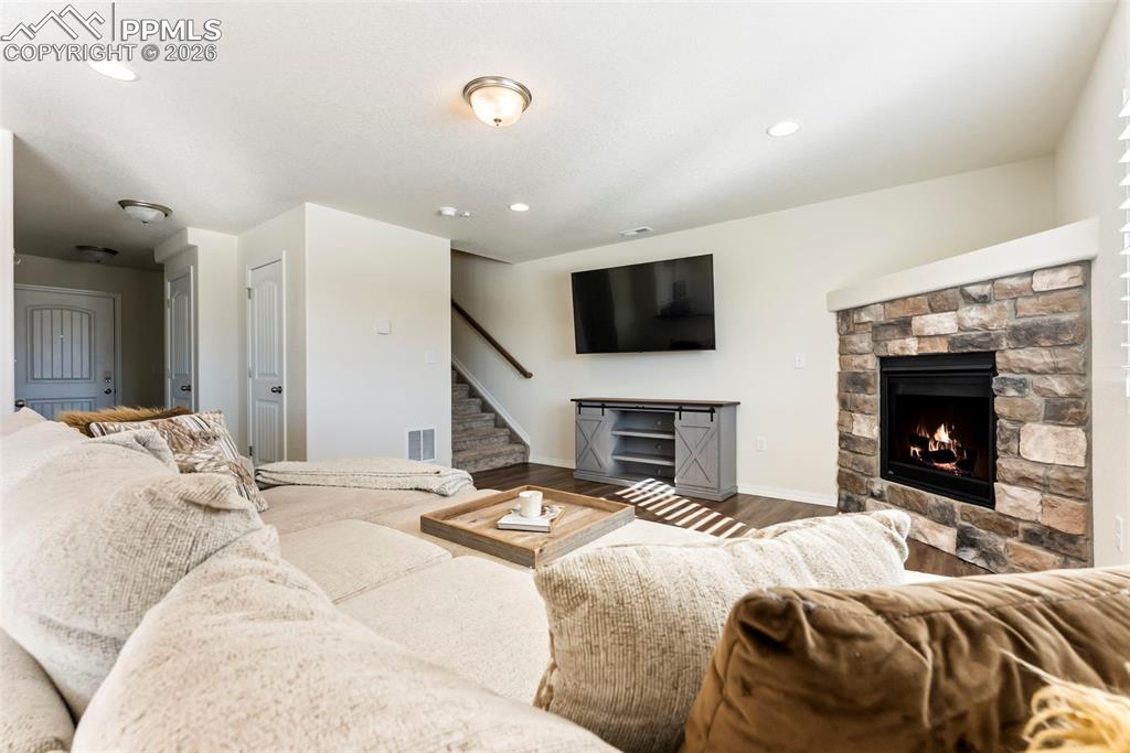 Image 5 of 38: Cozy living room with inviting corner fireplace