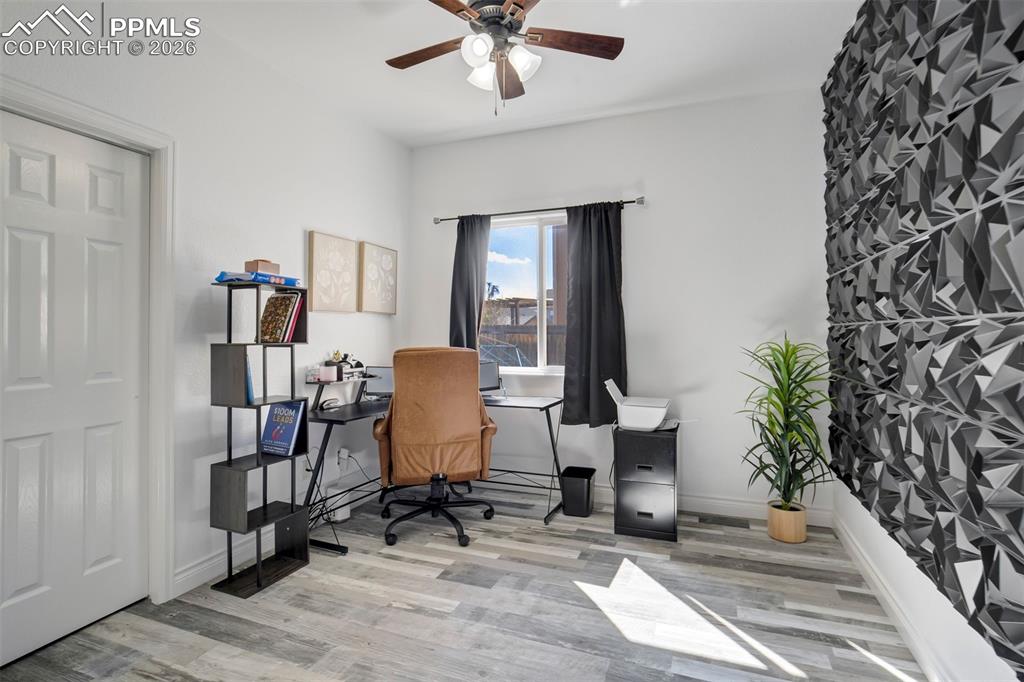 Image 16 of 46: Main level bedroom currently used as an office space.