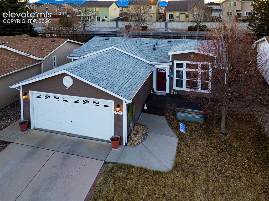 Image 2 of 30: Ranch-style residence featuring brown siding and a light gray shingle roof