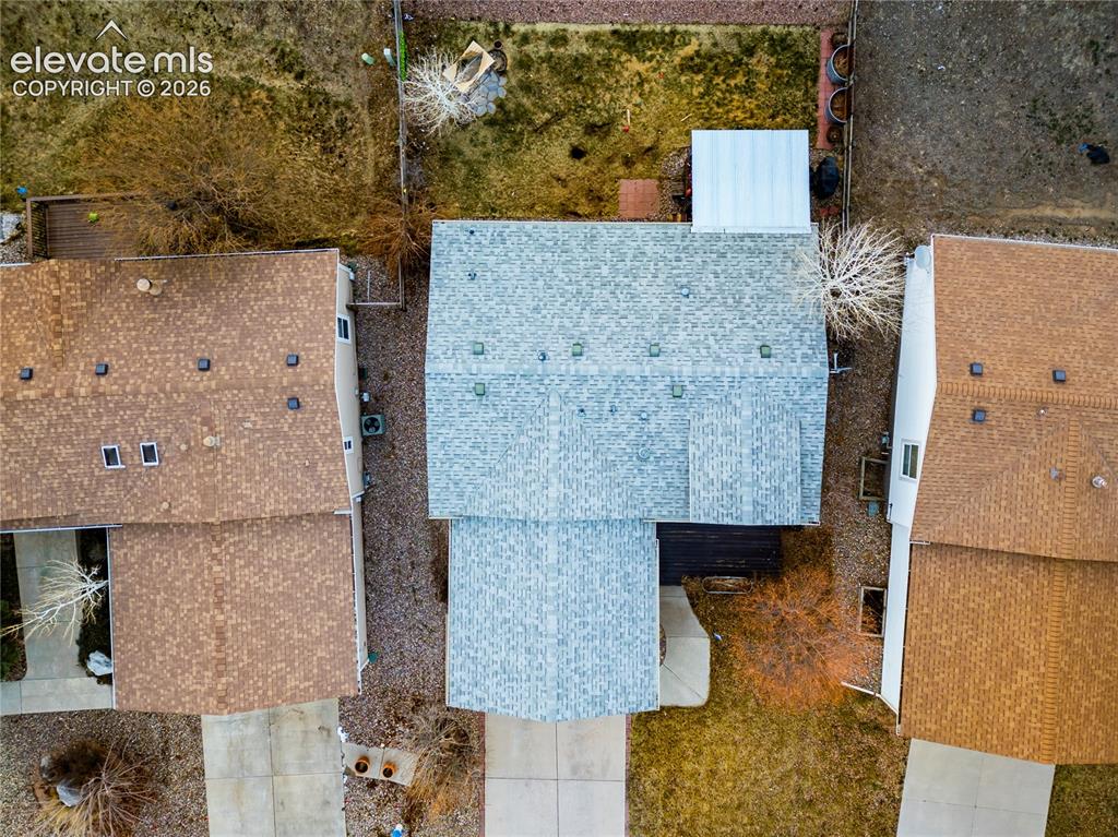 Image 3 of 30: Property features a light gray shingle roof, a detached structure with a wh