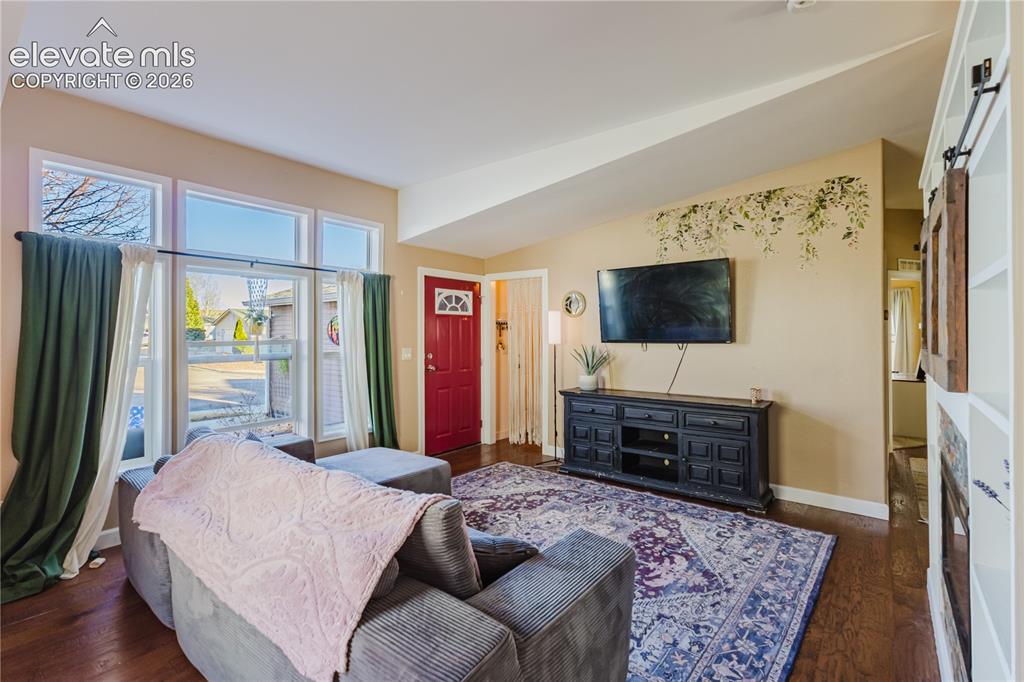 Image 9 of 30: Hardwood-style flooring throughout the main living area