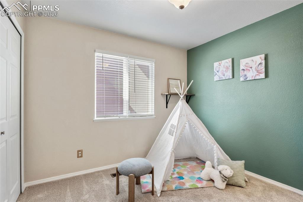 Image 25 of 50: Recreation room featuring light carpet and baseboards
