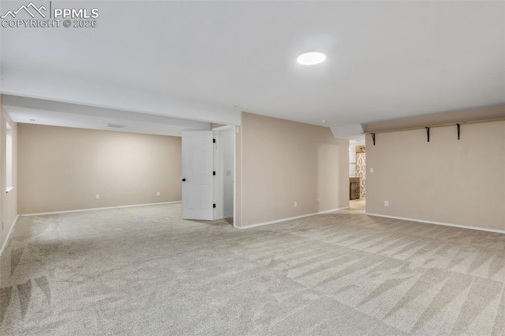 Image 30 of 50: Finished basement featuring light colored carpet and baseboards