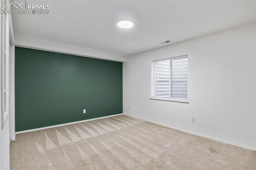 Image 31 of 50: Unfurnished room with light carpet and baseboards