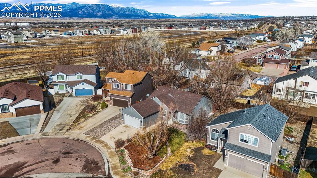 Image 39 of 50: Aerial view of residential area with mountains