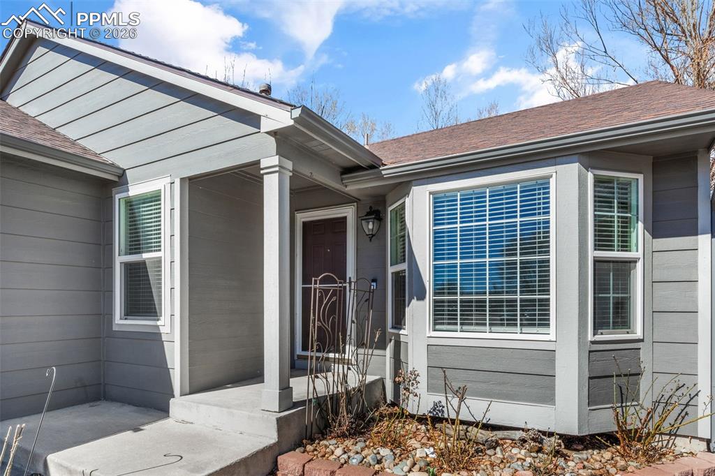 Image 4 of 50: Property entrance with a shingled roof
