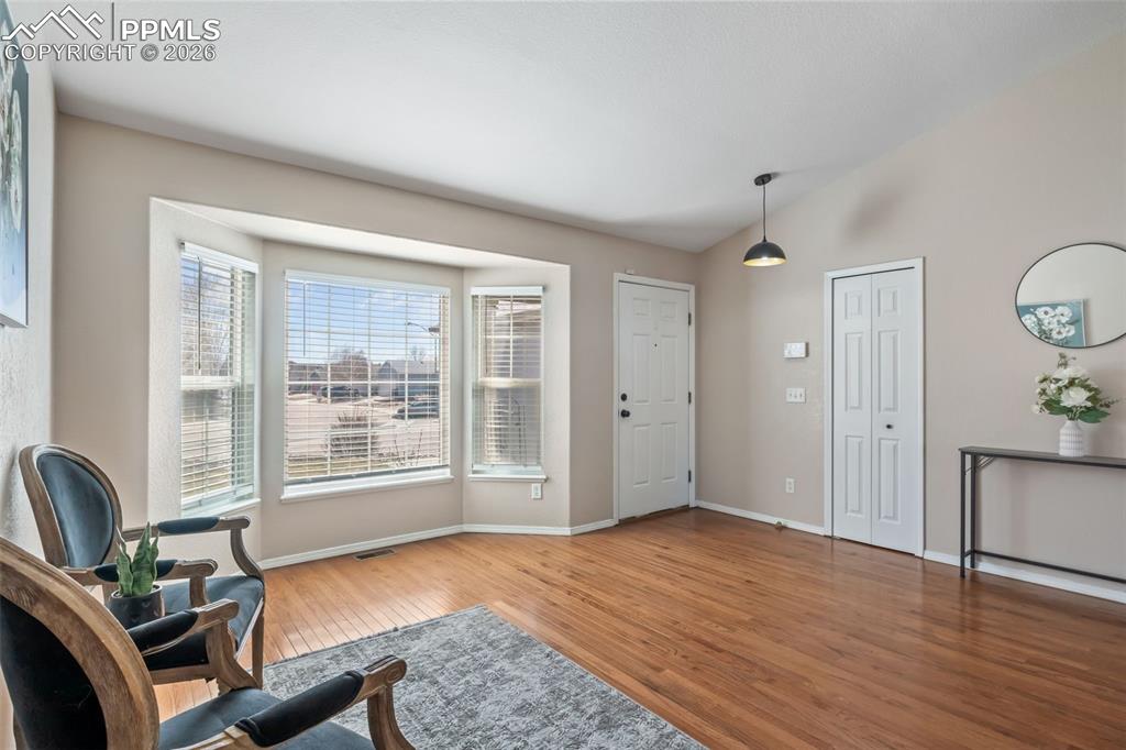 Image 6 of 50: Foyer featuring light wood-style flooring and vaulted ceiling