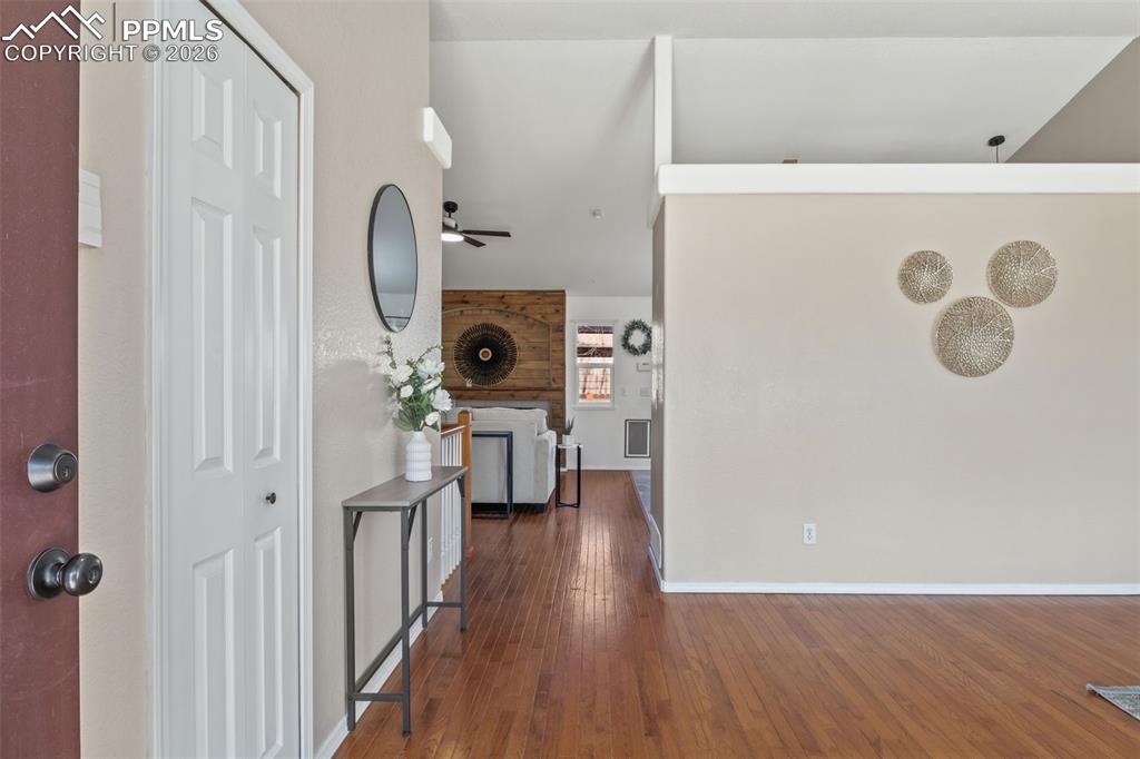 Image 7 of 50: Entryway with dark wood-style floors and a ceiling fan