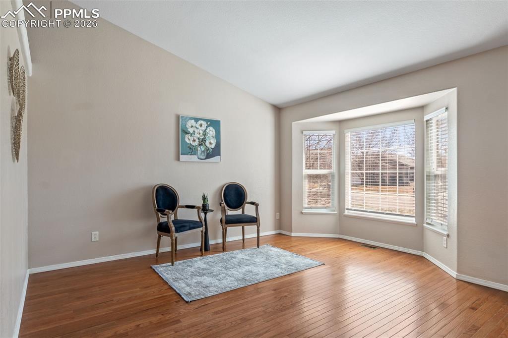 Image 8 of 50: Sitting room with hardwood / wood-style flooring and vaulted ceiling