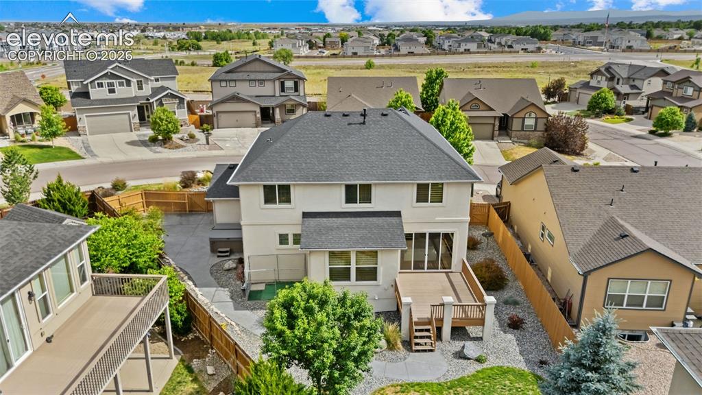 Image 45 of 50: rear deck, dog run area, full landscape and hot tub on the side yard