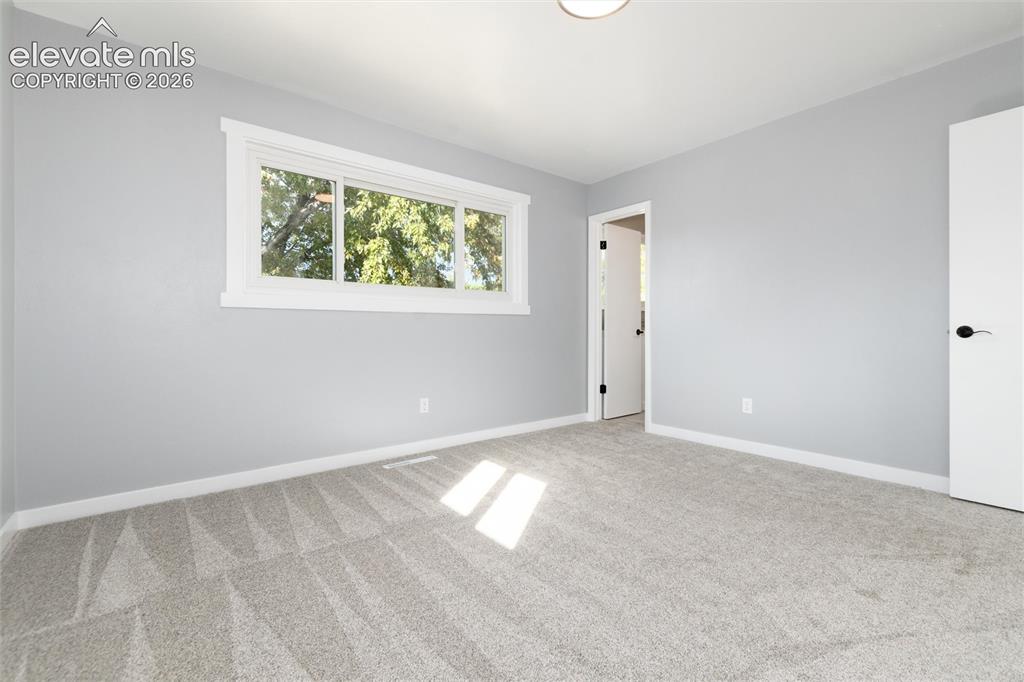 Image 29 of 47: Light gray wall paint, white trim, plush gray carpet, contemporary ceiling 