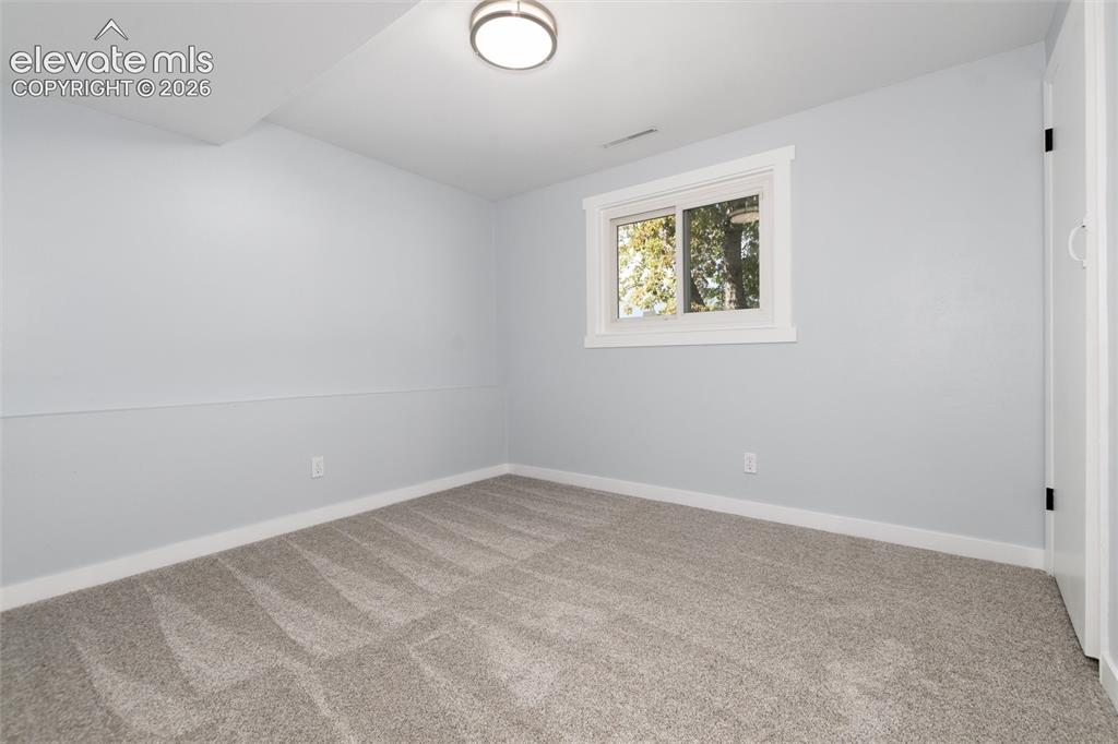 Image 34 of 47: Light gray wall paint, white trim, recessed window, flush-mount ceiling lig