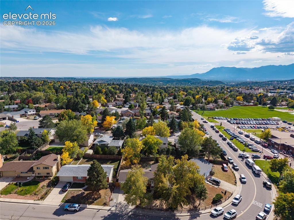 Image 45 of 47: Suburban neighborhood setting with established streetscaping and mountain b