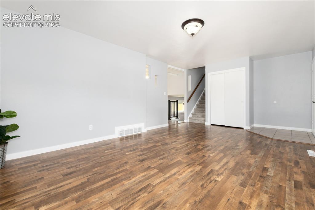 Image 9 of 47: Wood-finish flooring, light gray wall paint, recessed lighting, white slidi