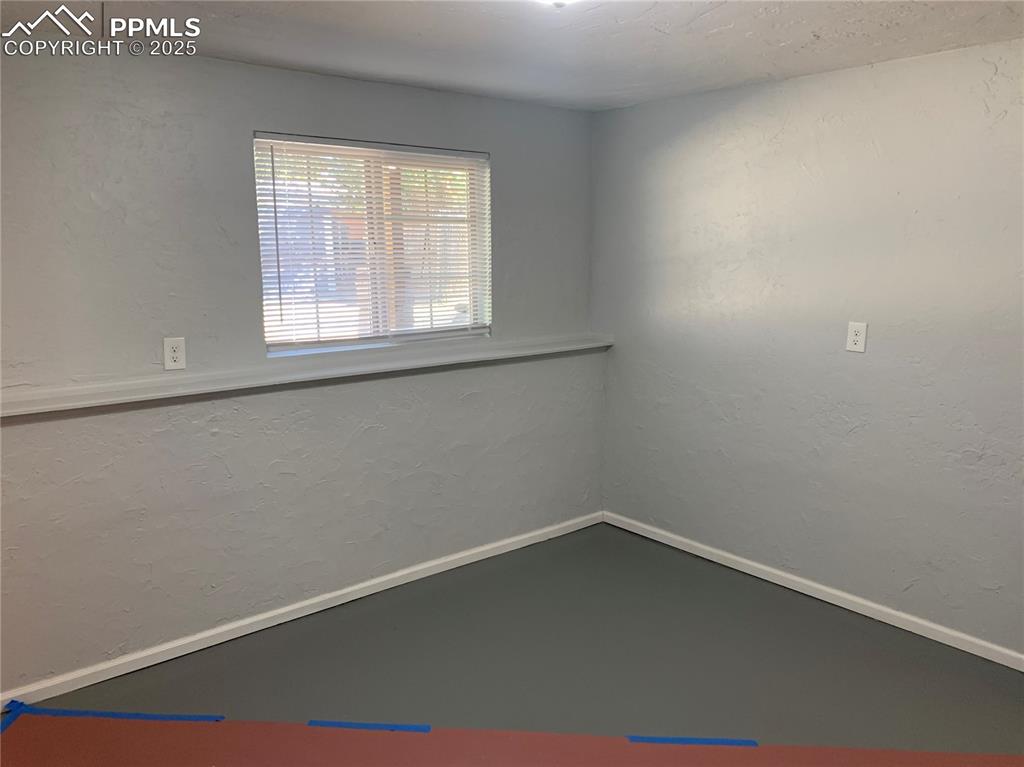 Image 30 of 32: Unfurnished room with a textured wall and baseboards