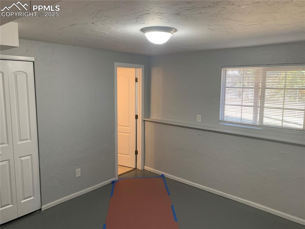 Image 31 of 32: Game room featuring a textured wall and a textured ceiling