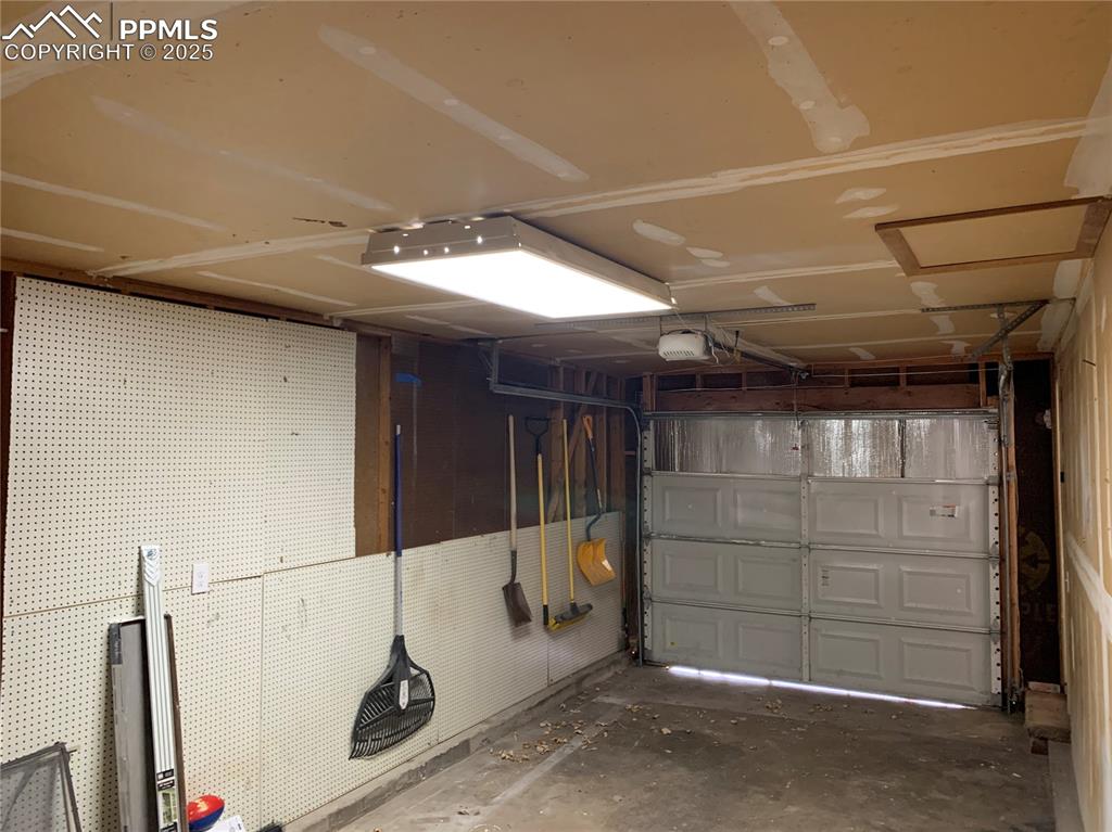 Image 32 of 32: Garage featuring a garage door opener