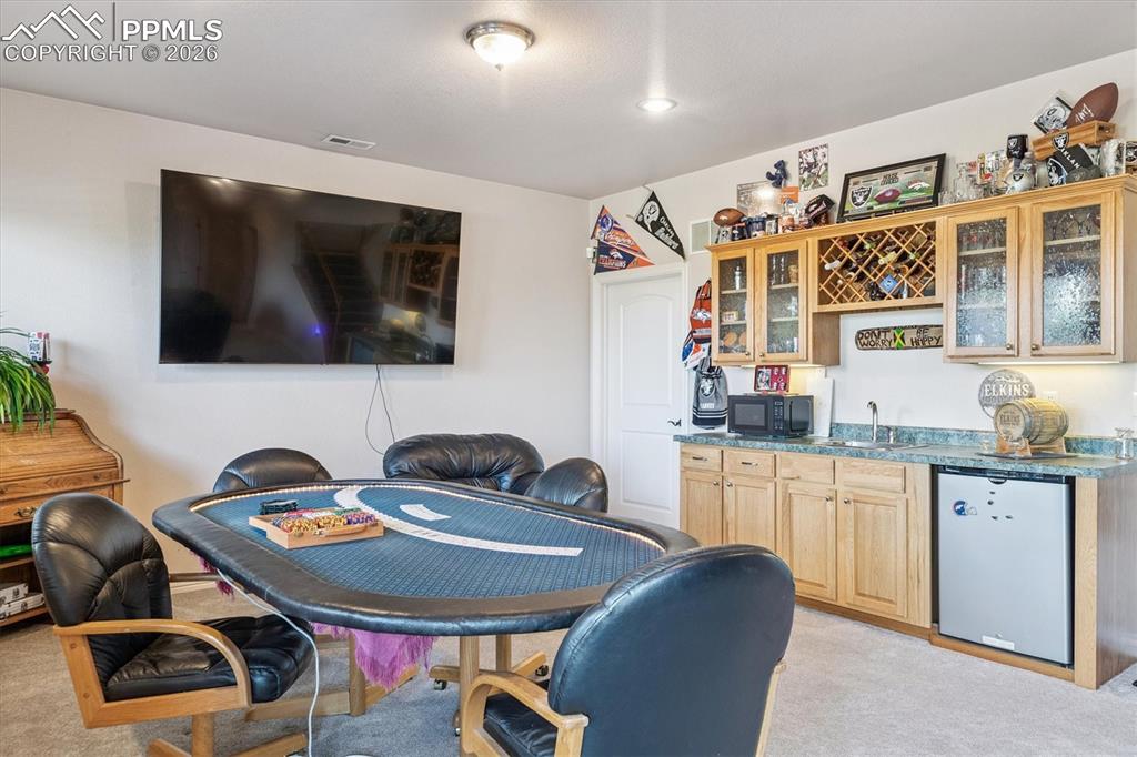 Image 23 of 32: Dining area with  wet bar
