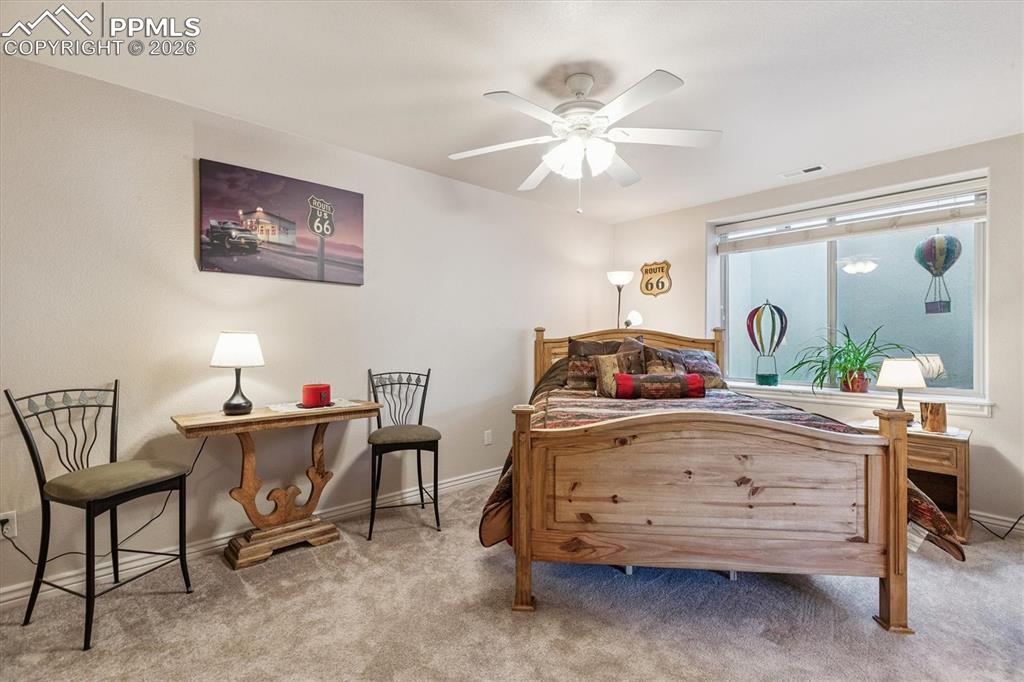 Image 27 of 32: Bedroom with carpet flooring and ceiling fan