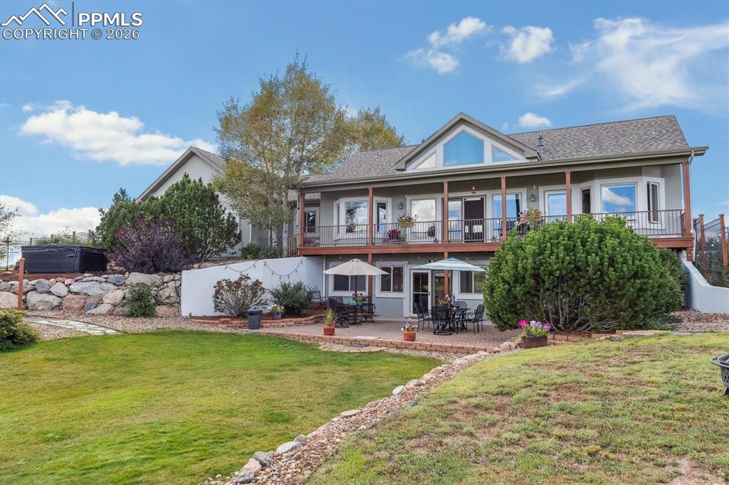 Image 30 of 32: Back of property featuring a patio, a balcony, and stucco siding
