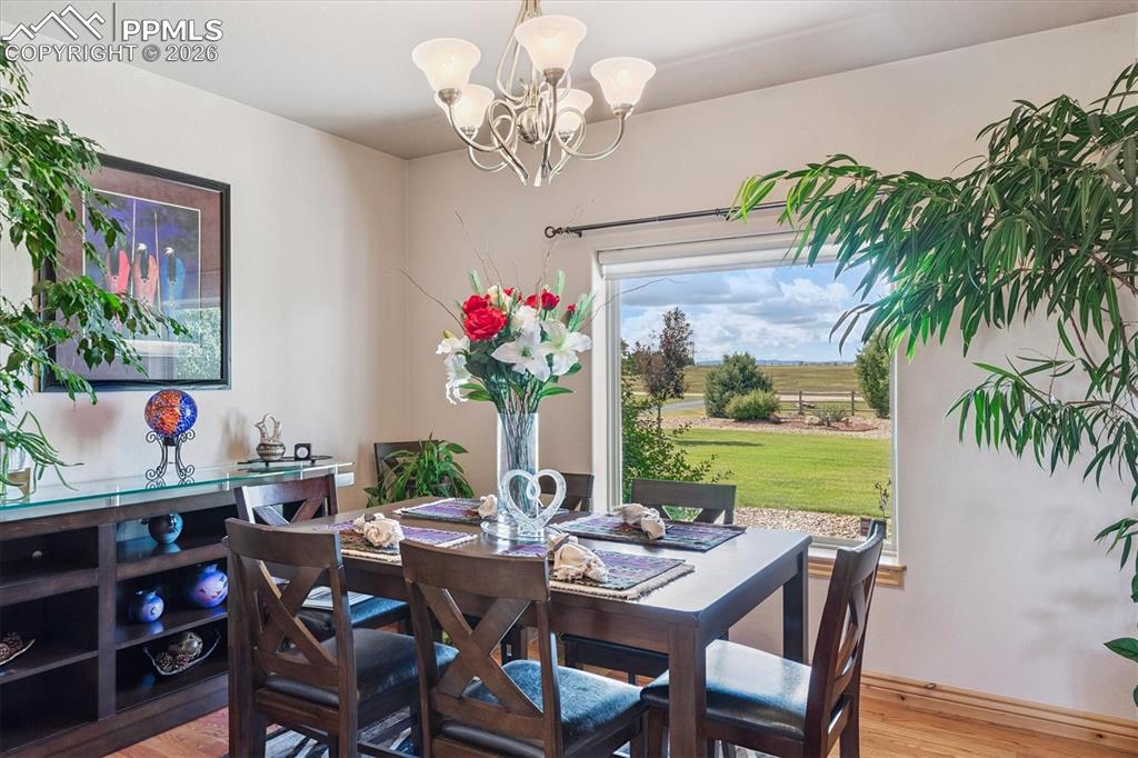 Image 8 of 32: Dining area featuring light wood-style floors and a chandelier