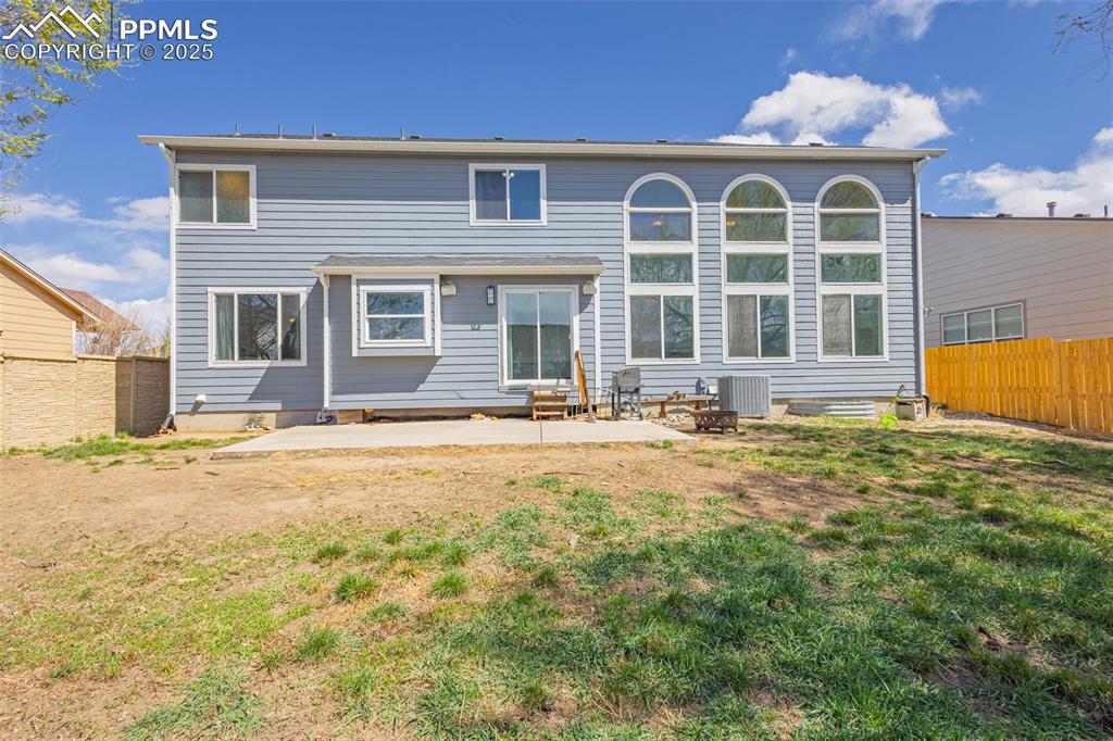 Image 16 of 17: Back of property featuring a fenced backyard and a lawn
