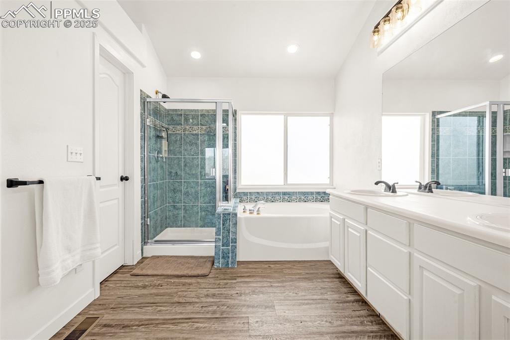 Image 9 of 17: 5-piece master bathroom with new tiling in the shower and new flooring.