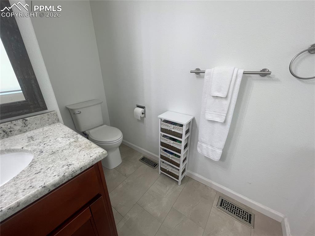 Image 13 of 19: Bathroom with vanity and light tile patterned floors