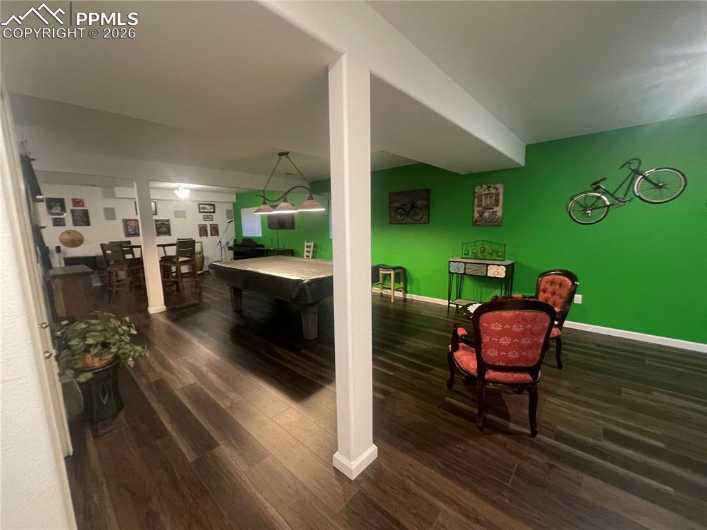 Image 14 of 19: Rec room with billiards and dark wood-style flooring