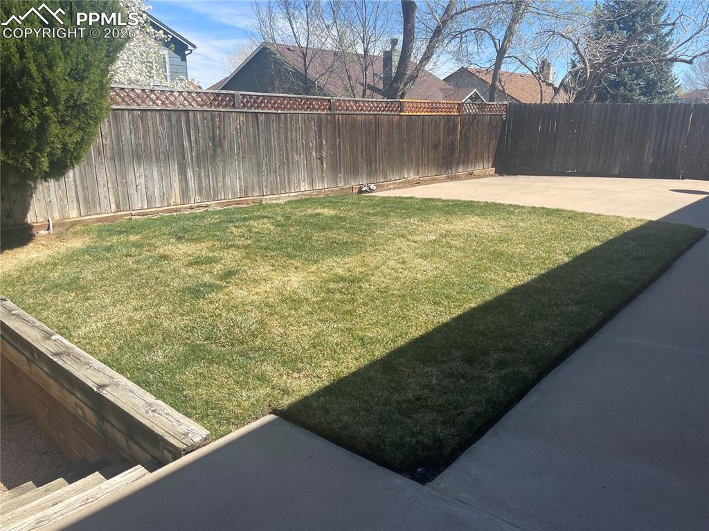 Image 18 of 19: View of fenced backyard