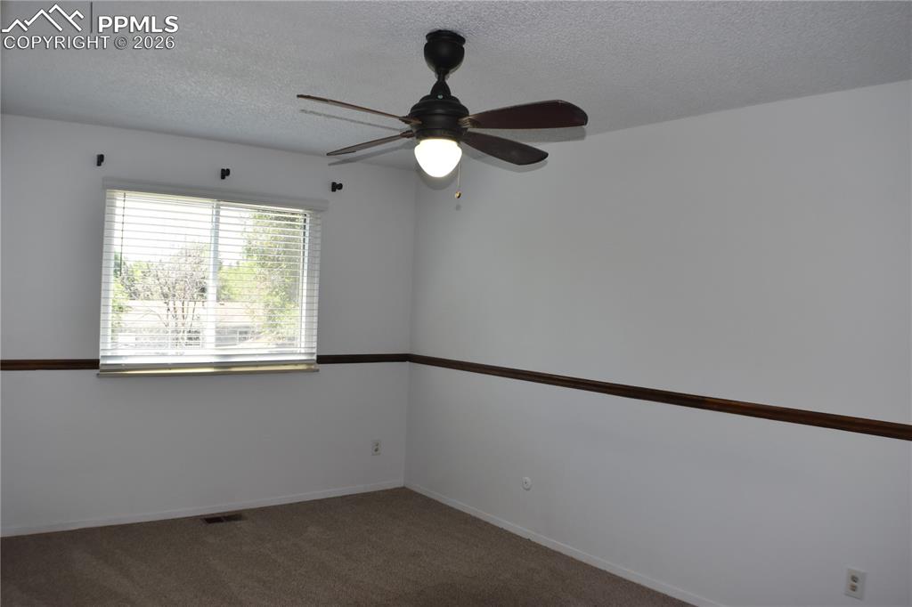 Image 11 of 40: Carpeted spare room featuring a ceiling fan and a textured ceiling