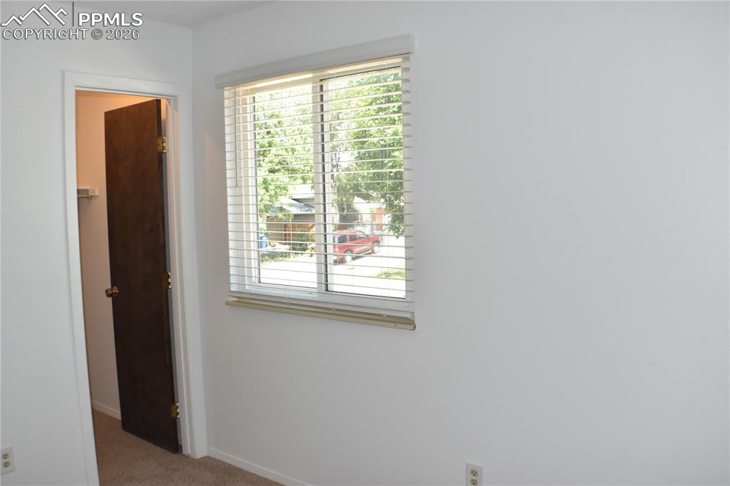 Image 12 of 40: Empty room with carpet and plenty of natural light