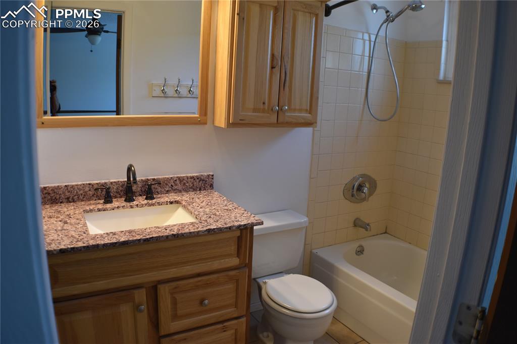 Image 14 of 40: Bathroom with vanity and shower / washtub combination
